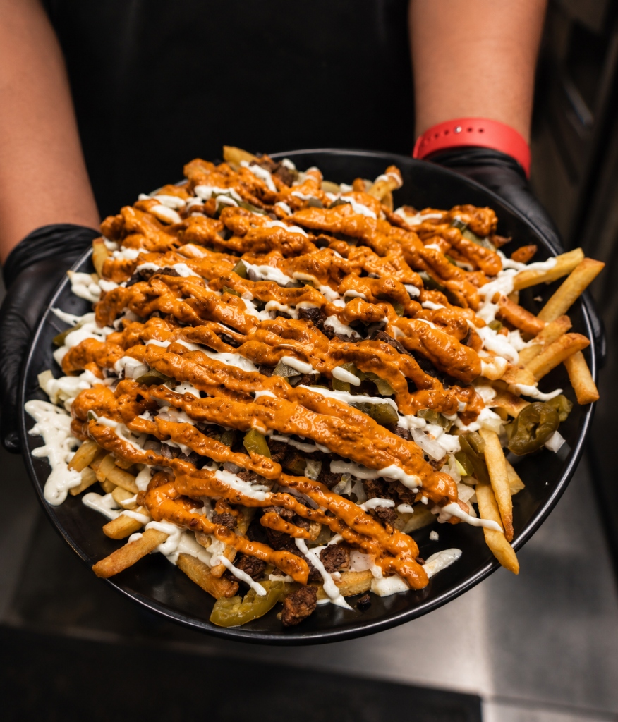 Gourmet loaded Mexican street fries with Oaxaca cheese and chipotle mayo