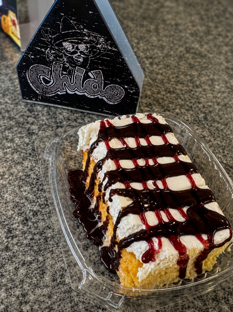 Authentic Mexican Tres Leches cake drizzled with rich chocolate and fruit syrup at Chido